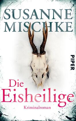 Die Eisheilige Das Buchcover zeigt einen weißen Hintergrund, der mit einem leicht gräulichen Verlauf versehen ist. In der Mitte befindet sich ein Tierkopf mit markanten, gewundenen Hörnern. Der Titel „Die Eisheilige“ ist in einer großen, pinkfarbenen Schriftart platziert, während der Autorenname „Susanne Mischke“ in eleganter, grauer Schrift oberhalb steht. Am unteren Rand ist das Wort „Kriminalroman“ in kleinerer Schrift zu sehen. Die Gesamtatmosphäre wirkt mysteriös und aufregend.