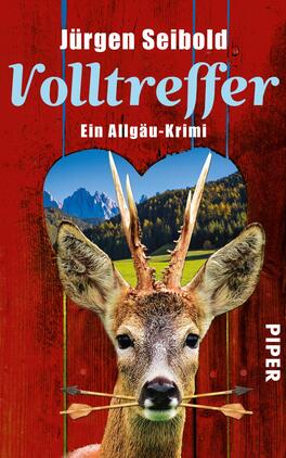 Volltreffer Das Buchcover zeigt ein rotes Holzdesign mit einer herzförmigen Aussparung. In dieser Aussparung ist eine malerische Alpenlandschaft mit Bergen und grünen Wiesen zu sehen. Im Vordergrund blickt ein Reh mit einem Pfeil zwischen den Augen direkt auf den Betrachter. Der Titel „Volltreffer“ von Jürgen Seibold ist in großen, hellblauen Buchstaben oben platziert, während der Untertitel „Ein Allgäu-Krimi“ in kleinerer Schrift darunter steht. Das Verlagslogo „PIPER“ befindet sich am rechten Rand.