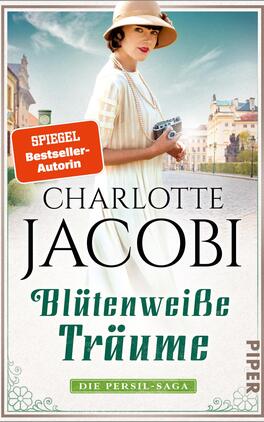 Blütenweiße Träume Das Buchcover zeigt eine elegante Frau in einem fließenden weißen Kleid mit einer breiten Sonnenhaube. Sie hält ein kleines Täschchen in der Hand und blickt anmutig in die Ferne. Der Hintergrund zeigt eine historische Stadtansicht mit Gebäuden im Stil der Belle Époque und einem hellen Himmel. Der Titel „Blütenweiße Träume“ ist in geschwungener Schrift in Grün unterhalb des Autorennamens „Charlotte Jacobi“, der in schwarzer, klassischer Schrift prominent platziert ist. Oben links befindet sich ein rotes Label mit dem Text „SPIEGEL-Bestseller-Autorin“.
