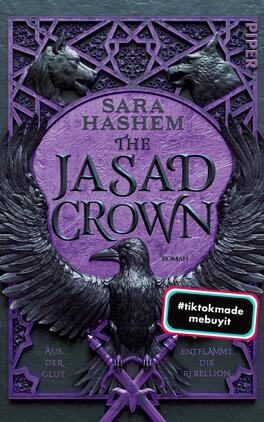 The Jasad Crown Das Buchcover zeigt einen dominierenden lila Farbton, der eine mystische Atmosphäre schafft. Im Zentrum befindet sich eine stilisierte Eule, die majestätisch gestaltet ist und die Aufmerksamkeit auf sich zieht. Der Titel „THE JASAD CROWN“ ist in markanter, geschwungener Schrift prominent platziert, während der Autorenname „SARA HASHEM“ darüber steht. Am unteren Rand ist der Schriftzug „Vorläufiges Cover“ in einem hellen, umrandeten Rechteck zu sehen. Ein Aufkleber in der oberen linken Ecke zeigt den Text „#tiktokmade mebuyit“.