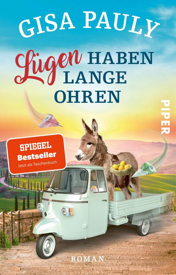Das Buchcover zeigt eine humorvolle, bunte Szenerie mit einem kleinen, weißen Transportfahrzeug, das eine Esel mit einer Ladung frischer Früchte transportiert. Im Hintergrund erstreckt sich eine malerische Landschaft mit sanften Hügeln und einem pastelblauen Himmel. Die Titelauflistung „Lügen haben lange Ohren“ ist in leuchtendem Rot und Blau gestaltet, während der Autor, Gisa Pauly, prominent am oberen Rand steht. Ein rotes Label mit dem Text „SPIEGEL Bestseller“ und dem Zusatz „Jetzt als Taschenbuch“ hebt die Popularität des Buches hervor.