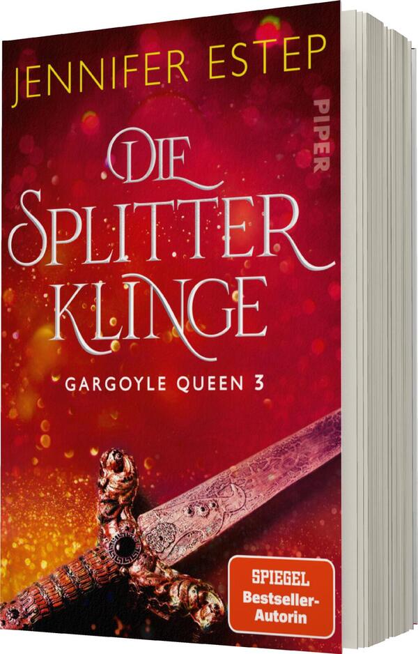 Das Buchcover zeigt einen faszinierenden, rot-goldenen Hintergrund, der eine mystische Atmosphäre schafft. Im Vordergrund ist ein verziertet Schwert zu sehen, das auf einer dunklen Fläche ruht. Der Titel „Die Splitterklinge“ ist in eleganter, geschwungener Schrift in goldener Farbe platziert. Darüber steht der Name der Autorin, Jennifer Estep, ebenfalls in Gold. Unten befindet sich der Hinweis „SPIEGEL Bestseller-Autorin“. Das Cover vermittelt eine spannende, fantastischen Stimmung und zieht den Betrachter an.
