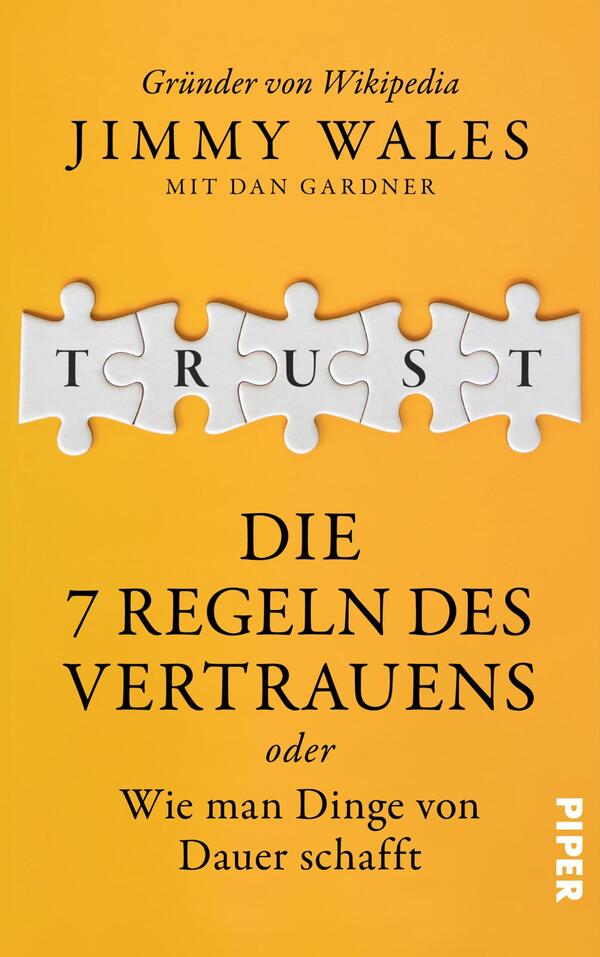 Das Buchcover zeigt einen leuchten orangenen Hintergrund. In der Mitte befindet sich ein Puzzlestück, auf dem das Wort „TRUST“ in großen, weißen Buchstaben steht. Darunter ist der Titel „DIE 7 REGELN DES VERTRAUENS“ in fetter, schwarzer Schrift platziert. Darunter steht in kleinerer Schrift: „oder Wie man Dinge von Dauer schafft“. Oben ist der Autor „Jimmy Wales“ sowie „mit Dan Gardner“ in eleganter, schwarzer Typografie angeordnet.