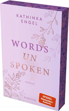 Words unspoken Das Buchcover zeigt einen sanften lila Hintergrund, der mit zarten, nostalgisch anmutenden Pflanzenornamenten in Weiß dekoriert ist. Der Titel „WORDS UN SPOKEN“ hebt sich in markanten, goldenen Buchstaben ab und vermittelt eine elegante Stimmung. Darunter steht klein der Hinweis „Roman“. Oben links sind der Name der Autorin, Kathinka Engel, und das Verlagslogo sichtbar. In der unteren rechten Ecke befindet sich ein orangener Button mit dem Text „SPIEGEL-Bestseller-Autorin“.