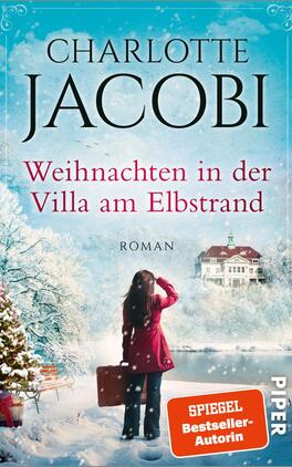 Weihnachten in der Villa am Elbstrand Das Buchcover zeigt eine winterliche Szene mit schneebedeckten Bäumen und einer eleganten Villa am Elbstrand im Hintergrund. Im Vordergrund steht eine Frau mit schulterlangen, dunklen Haaren, die einen roten Mantel trägt und zum Gebäude blickt. Der Titel „Weihnachten in der Villa am Elbstrand“ ist in großen, roten Buchstaben oben platziert, gefolgt vom Autorennamen „Charlotte Jacobi“. Unten in der Ecke steht „Roman“ in kleinerer Schrift. Die Atmosphäre ist festlich und romantisch.