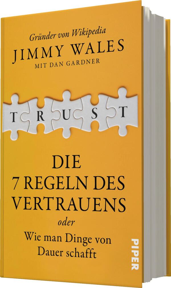 Das Buchcover zeigt einen gelben Hintergrund mit einem großen, weißen Puzzlestück, das den Titel „TRUST“ in prägnanter, blauer Schrift enthält. Darunter steht in weißer Schrift: „DIE 7 REGELN DES VERTRAUENS oder Wie man Dinge von Dauer schafft“. Der Autor, Jimmy Wales, wird prominent oben auf dem Cover genannt, gefolgt von Dan Gardner. Die Schrift ist klar und gut lesbar, wodurch eine einladende Atmosphäre entsteht.