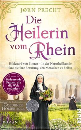Die Heilerin vom Rhein Das Buchcover zeigt eine sanfte, pastellfarbene Hintergrundgestaltung mit einem historischen, ruhigen Setting. Im Vordergrund steht eine Frau in einem einfachen schwarzen Gewand mit Haube, die Kräuter in der Hand hält. Der Titel „Die Heilerin vom Rhein“ ist in elegant geschwungener Schrift in Violett dargestellt, untertitelt von „Hildegard von Bingen – In der Naturheilkunde fand sie ihre Berufung, den Menschen zu helfen“, in einem klaren Schriftstil. Oben links befindet sich ein runder Auszeichnungshinweis mit dem Text „Bedeutende Frauen, die die Welt verändern“. Das Cover vermittelt eine Atmosphäre von Wissen und Heilkunst.