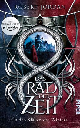 Das Rad der Zeit 9 Das Buchcover zeigt eine dramatische Szenerie mit einem rot-blauen Farbverlauf im Hintergrund. Im Mittelpunkt ist ein schwarzer Ring, der eine stilisierte Schlange darstellt. Innerhalb des Rings ist eine mystische Landschaft mit einem Schloss und einer Figur in rotem Umhang zu sehen. Oberhalb des Rings stehen die Worte „Das Rad der Zeit“ in großer, eleganter Typografie, während „In den Klauen des Winters“ darunter in kleinerer Schrift erscheint. Der Name des Autors, Robert Jordan, befindet sich oben. Ein Aufkleber kündigt die Serie bei „prime video“ an.